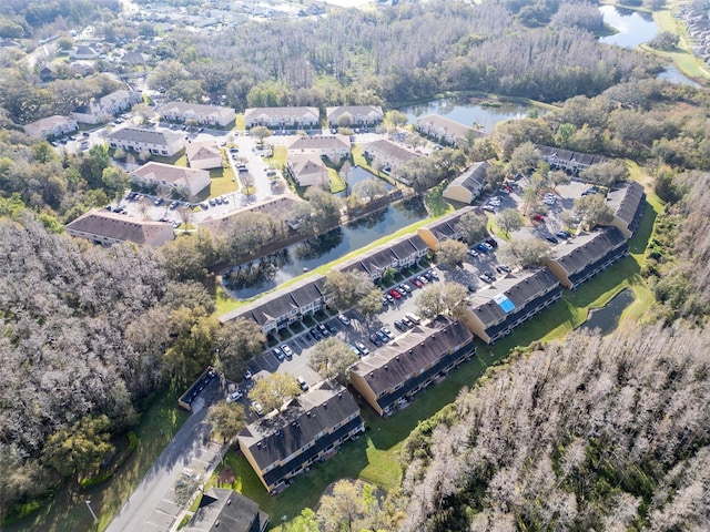 drone / aerial view featuring a water view and a residential view