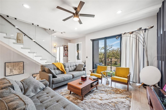 living room with ceiling fan, stairs, wood finished floors, and recessed lighting