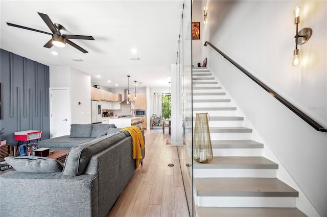 living room with recessed lighting, visible vents, stairway, light wood-style floors, and a ceiling fan