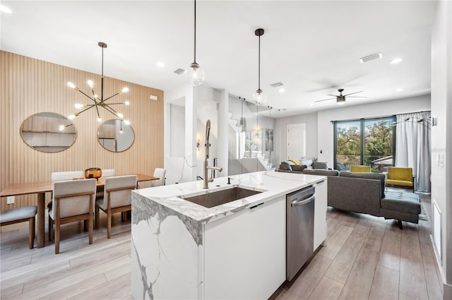 kitchen with visible vents, open floor plan, a sink, light wood-type flooring, and dishwasher