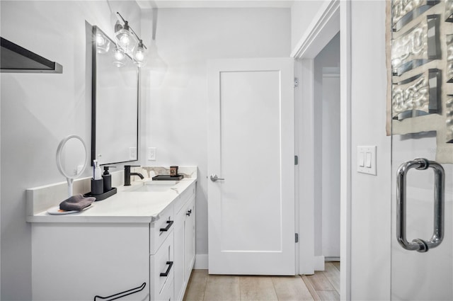 bathroom featuring wood finished floors and vanity