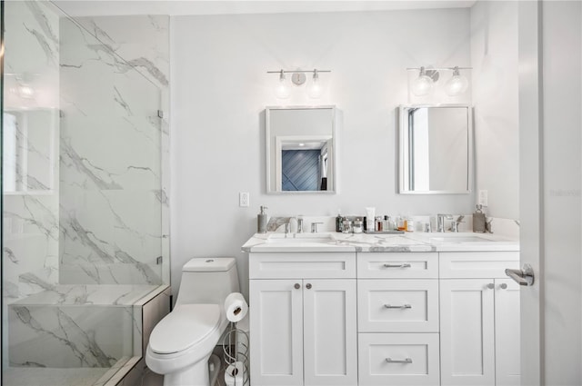 full bathroom with toilet, a marble finish shower, double vanity, and a sink