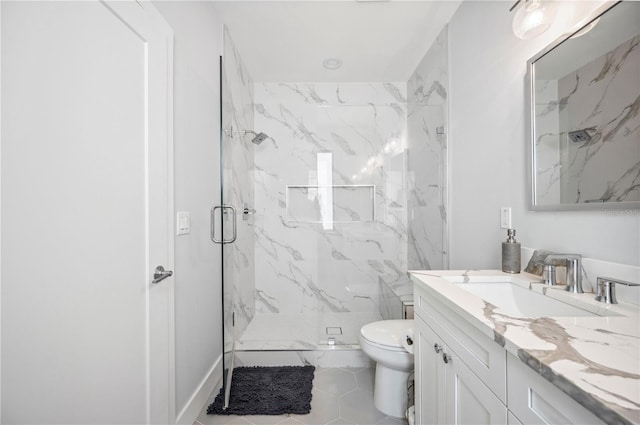 bathroom featuring a marble finish shower, vanity, and toilet