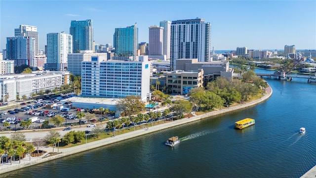 birds eye view of property featuring a water view and a city view