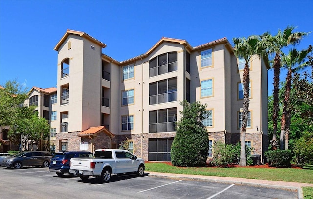 view of property featuring uncovered parking