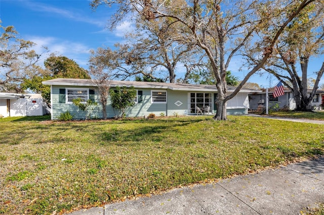 single story home featuring a garage, a front yard, brick siding, and driveway