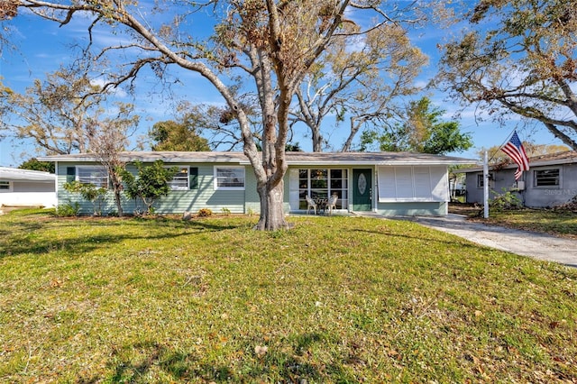 ranch-style home featuring driveway and a front lawn