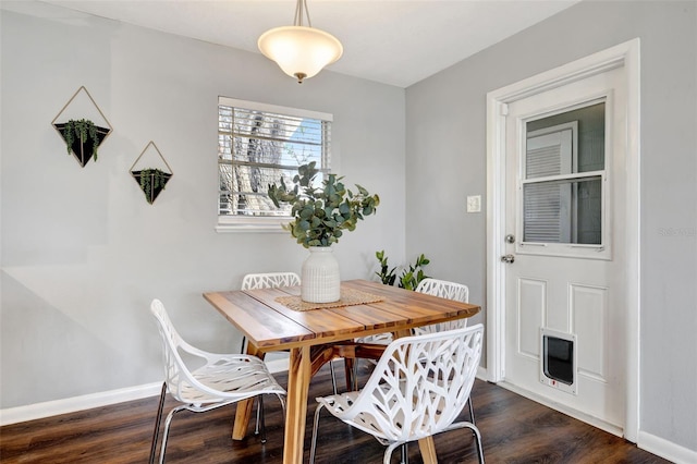 dining room featuring dark wood finished floors and baseboards