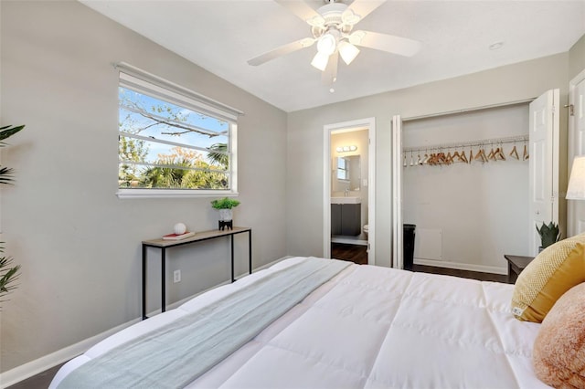 bedroom featuring a ceiling fan, baseboards, a closet, and ensuite bathroom