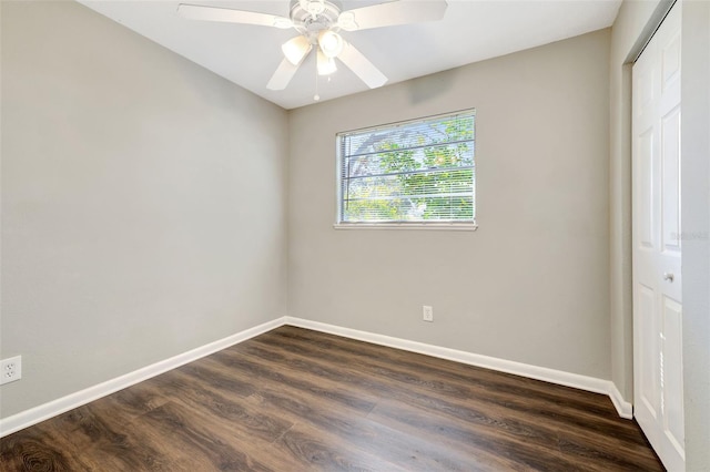 unfurnished bedroom featuring dark wood-style floors, ceiling fan, baseboards, and a closet