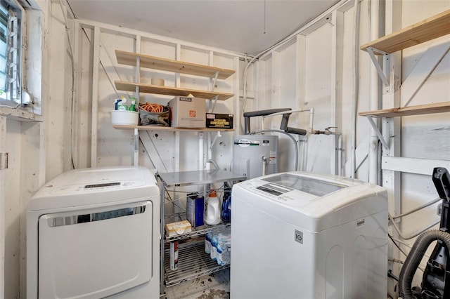 washroom featuring water heater and independent washer and dryer