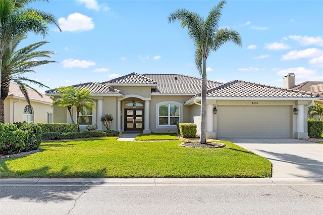 mediterranean / spanish-style house featuring stucco siding, a tile roof, french doors, concrete driveway, and an attached garage