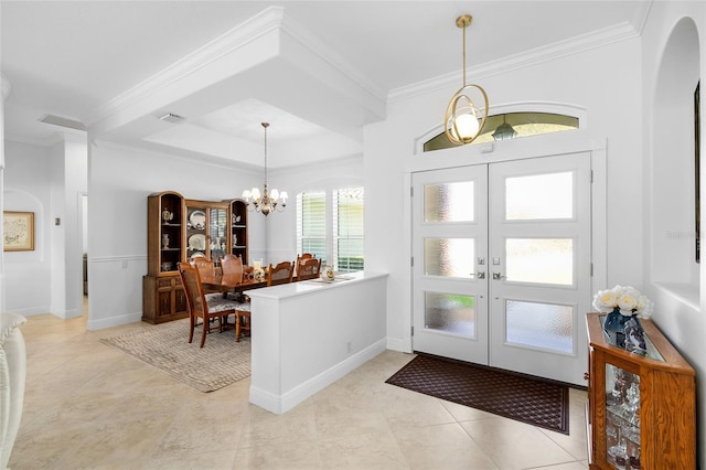 foyer entrance with visible vents, ornamental molding, french doors, arched walkways, and a notable chandelier