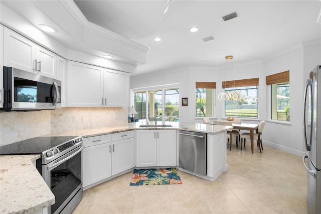 kitchen featuring visible vents, ornamental molding, appliances with stainless steel finishes, a peninsula, and a sink