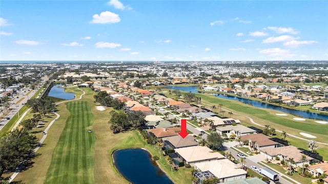 birds eye view of property with a residential view, a water view, and view of golf course