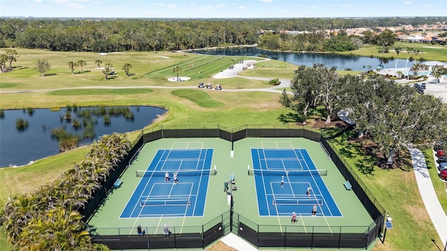 birds eye view of property with a water view and golf course view