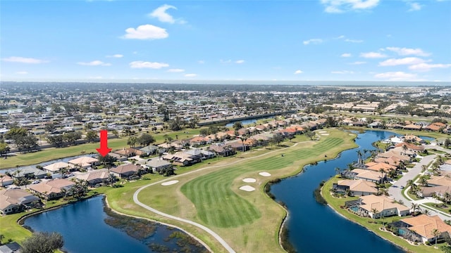 bird's eye view with view of golf course, a water view, and a residential view