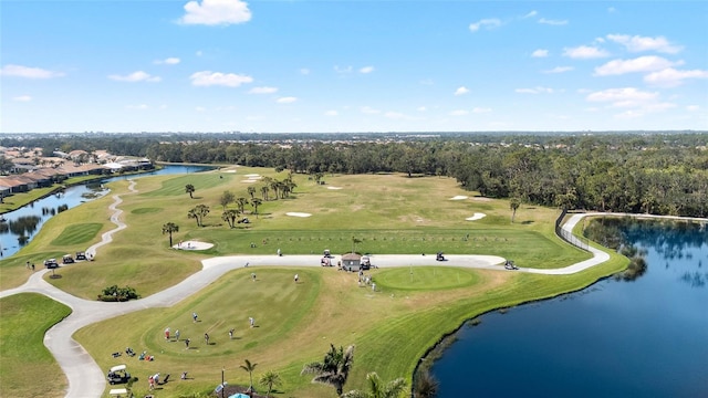 birds eye view of property with view of golf course and a water view