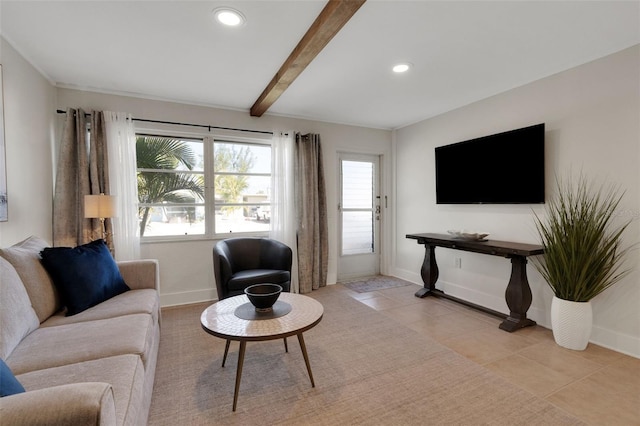 living room featuring light tile patterned floors, beam ceiling, and baseboards