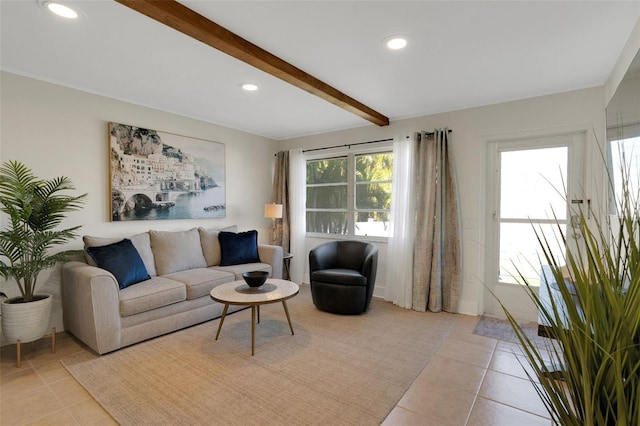 living room featuring beamed ceiling, plenty of natural light, and light tile patterned flooring