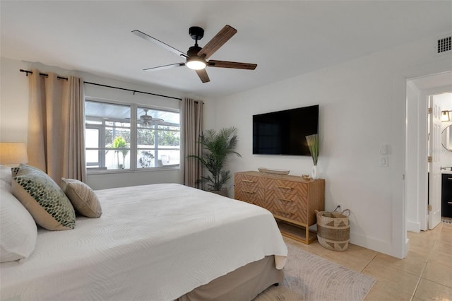 bedroom with light tile patterned floors, ceiling fan, visible vents, and baseboards