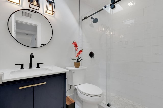 bathroom with visible vents, a shower stall, toilet, and vanity