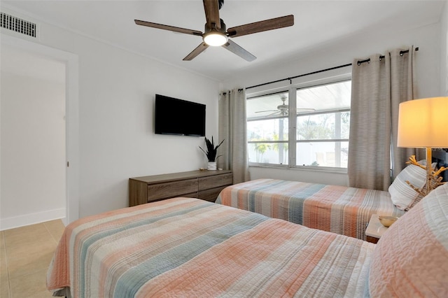 bedroom with ceiling fan, visible vents, baseboards, and light tile patterned flooring