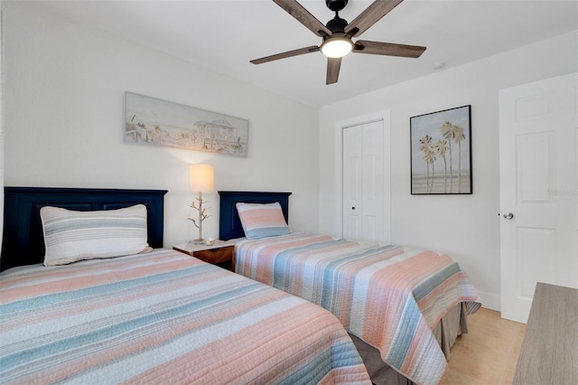 bedroom featuring a ceiling fan, a closet, and baseboards