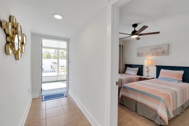 bedroom featuring light tile patterned floors, ceiling fan, baseboards, and access to exterior