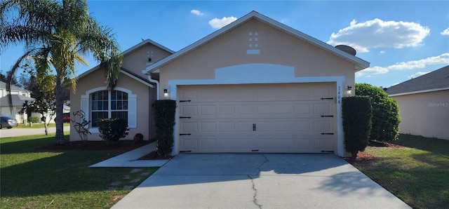 ranch-style house with driveway, a garage, a front yard, and stucco siding