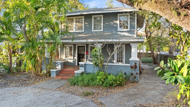 view of front of property with fence and a porch