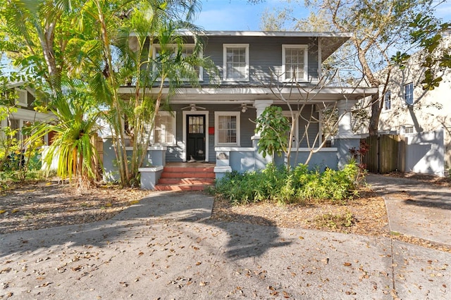 view of front facade featuring covered porch, driveway, fence, and a ceiling fan