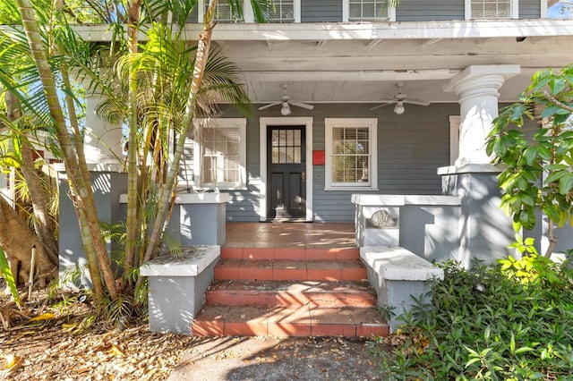 doorway to property featuring a porch and a ceiling fan