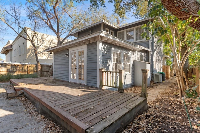 exterior space featuring a deck, french doors, cooling unit, and fence