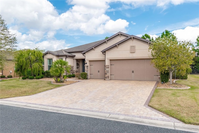 view of front of house featuring a garage, a front lawn, decorative driveway, and stucco siding