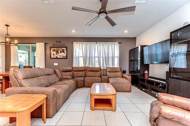 living area with light tile patterned floors, visible vents, ceiling fan with notable chandelier, and recessed lighting