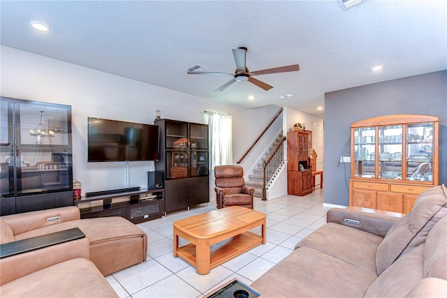 tiled living area with visible vents, stairs, recessed lighting, a textured ceiling, and a ceiling fan