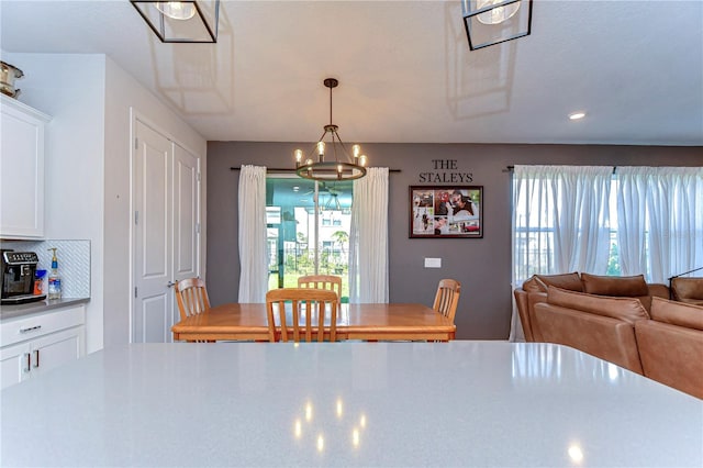 dining space with a healthy amount of sunlight and an inviting chandelier