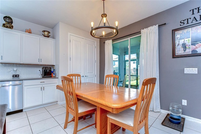 dining space with light tile patterned floors, baseboards, and a chandelier