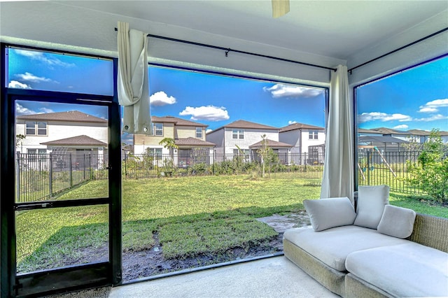 sunroom featuring a residential view