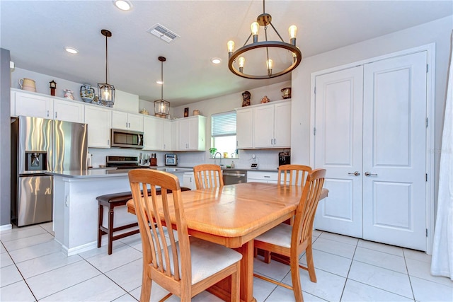 dining area with light tile patterned floors, visible vents, a chandelier, and recessed lighting