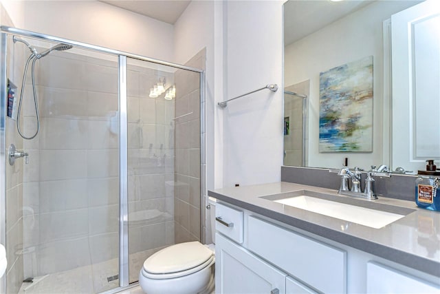 full bathroom with a stall shower, toilet, and vanity
