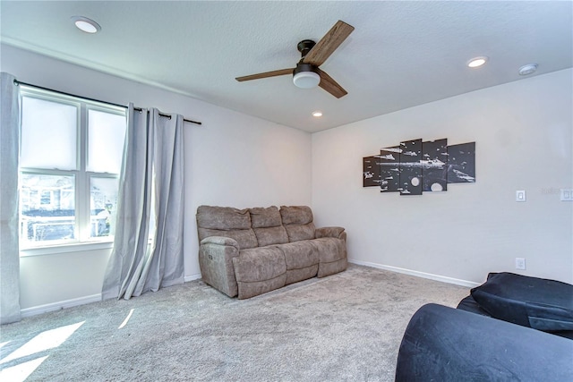 carpeted living area featuring recessed lighting, baseboards, and a ceiling fan