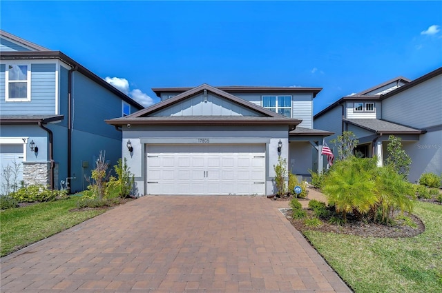 view of front of property featuring decorative driveway, a garage, and stucco siding