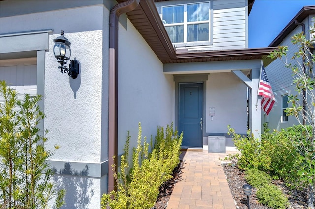 entrance to property with stucco siding