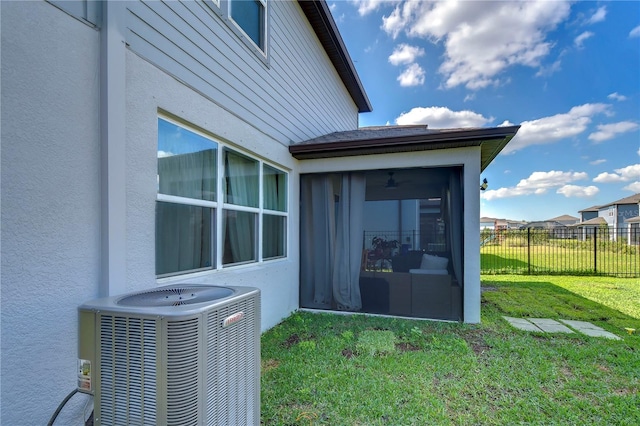 exterior space featuring central air condition unit, fence, and stucco siding