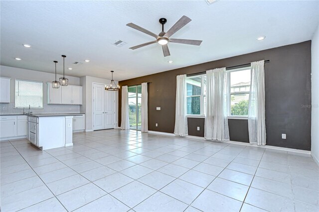 17805 Everlong Dr, Land O Lakes, FL 34638 - unfurnished living room with ceiling fan, healthy amount of natural light, light tile patterned floors, and recessed lighting