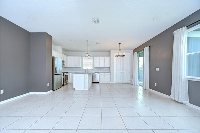 17805 Everlong Dr, Land O Lakes, FL 34638 - kitchen with appliances with stainless steel finishes, a chandelier, healthy amount of natural light, and light countertops