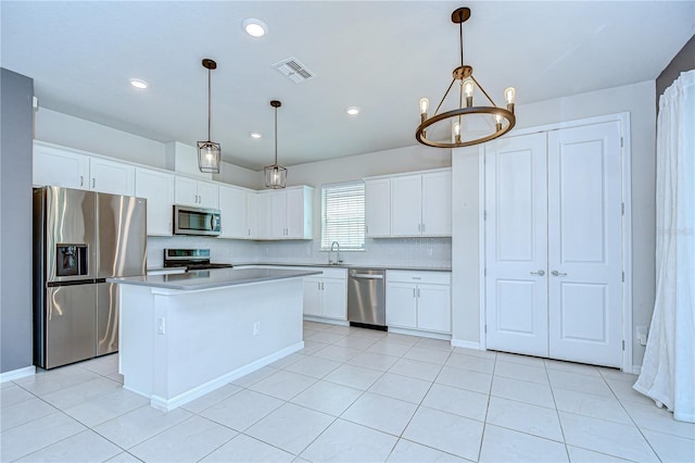 17805 Everlong Dr, Land O Lakes, FL 34638 - kitchen with appliances with stainless steel finishes, white cabinets, a chandelier, light countertops, and recessed lighting