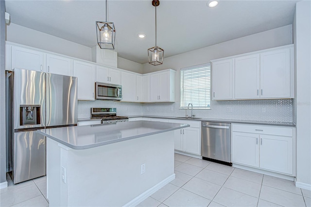 17805 Everlong Dr, Land O Lakes, FL 34638 - kitchen featuring stainless steel appliances, white cabinets, tasteful backsplash, a center island, and recessed lighting